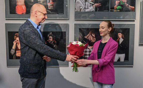 Robert Sękiewicz wręczający kwiaty Dorocie Orzełek podczas finisażu wystawy
