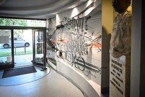 wejście do Ośrodka Promocji Kultury Gaude Mater w Częstochowie i mural Bartłomieja Stypki na ścianie